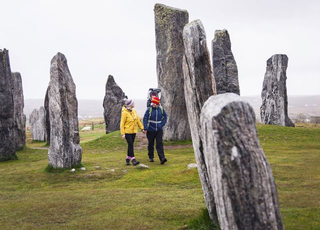 A family walking through the Calanais Standing Stones, Lewis