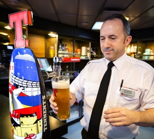 Ferry staff pouring a pint of beer