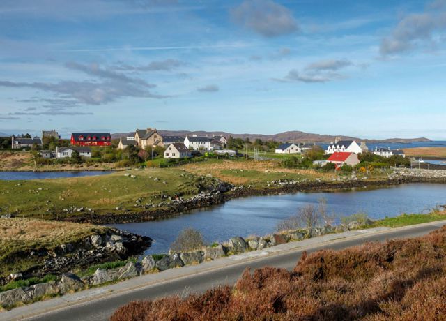 A view of the houses in the village of Lochmaddy, across inland lochs, North Uist.