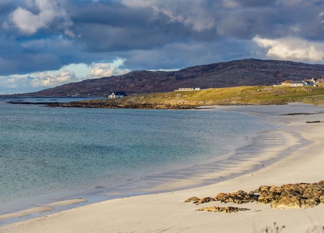 A sandy beach and view along the coastline on South Uist