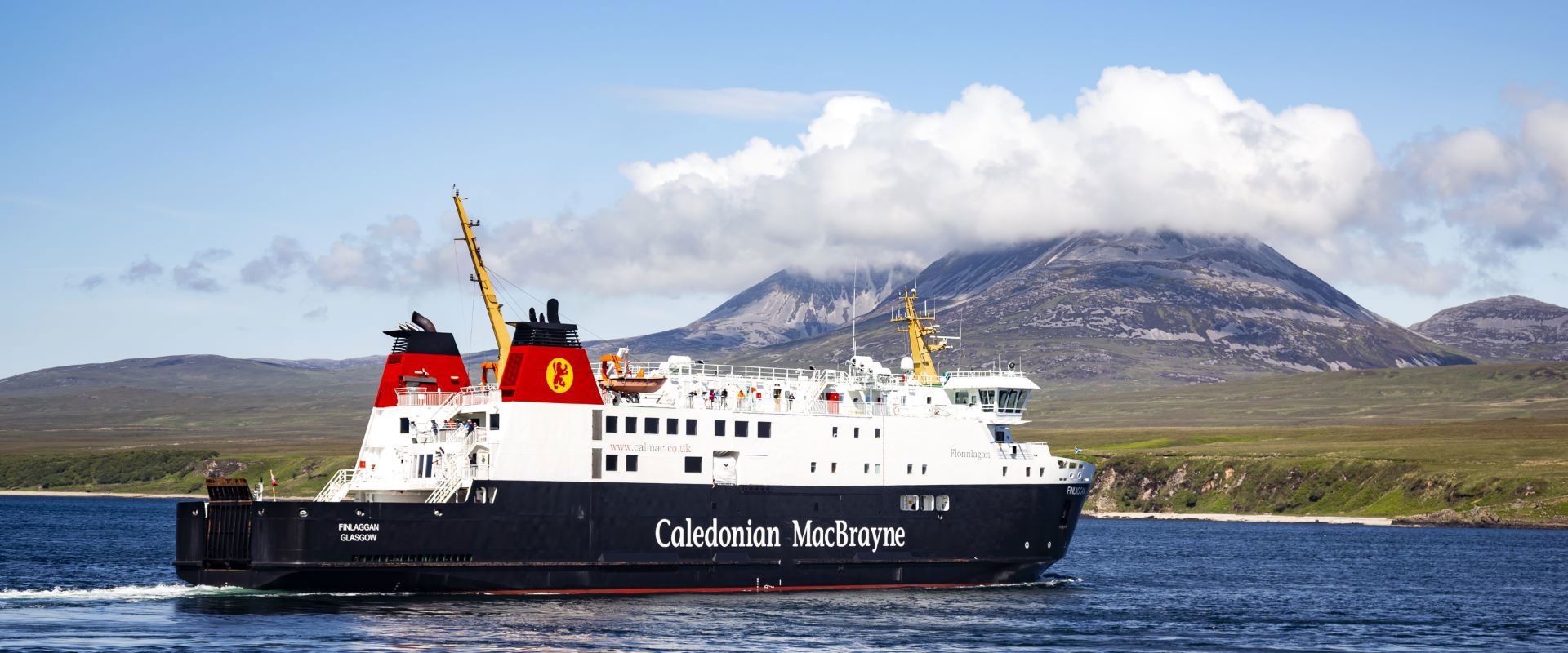 Caledonian MacBrayne ferry to and from Islay called MV Finlaggan, sailing with the cloud covered "Paps of Jura" in the background.