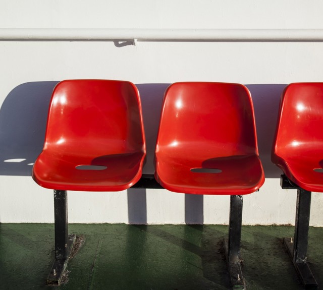 three red chairs out on deck