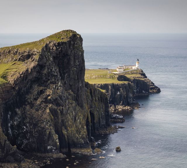 Rocky landscape and coastline with Neist Point Lighthouse sitting proudly at the end.